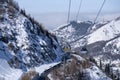 Cable car way on snowy mountains background. Gondola lift in winter mountains.