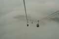 Cable cars traveled in the fog.