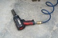 The cable of a compressed air gun used to unscrew the screws on the car`s wheels. Vulcanization.