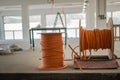 Cable drums with orange fiber cable on a construction site