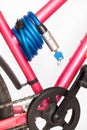 Cable locks with the locking mechanism permanently integrated, pink bicycle frame on white background Royalty Free Stock Photo