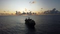 Cable ship sailing near Fiji at sunset Royalty Free Stock Photo