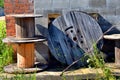 Cable Spools Stacked by Old Building Royalty Free Stock Photo