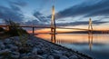 Cable- Stayed Bridge at Dusk with Reflections on Calm Water cable-stayed bridge architecture Royalty Free Stock Photo