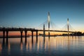 The cable-stayed bridge over Petrovsky fairway and the tower of Lakhta center, at sunset, Saint-Petersburg,