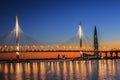 The cable-stayed bridge over Petrovsky fairway and the tower of Lakhta center, at sunset, Saint-Petersburg,