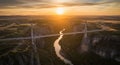 A cable-stayed bridge spans a deep canyon with a river flowing below, illuminated by Royalty Free Stock Photo
