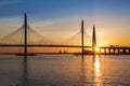 Cable-stayed bridge of Western high-speed diameter through Peter`s fairway and the tower of Lakhta center, at sunset, Saint-Peter