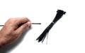 The cable tie in hand and bundle of black cable tie Royalty Free Stock Photo