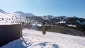 Cable way car in Goderdzi ski resort with old wooden houses in Adjara mountains in winter