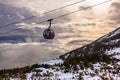 Cableway cabin above the clouds at sunset Royalty Free Stock Photo