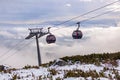 Cableway cabin above the clouds at sunset