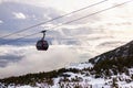 Cableway cabin above the clouds at sunset Royalty Free Stock Photo