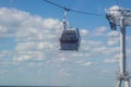 Cableway cabin against the background of clouds.unusual type of transport