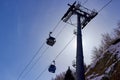 cableway cabins and intermediate support tower on the background of the blue sky