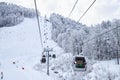 Cableway lift cabins on snowy mountain background beautiful winter scenery