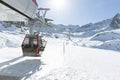 Cableway lift cable cars, gondola cabins on winter snowy mountains background beautiful scenery.