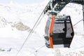 Cableway lift cable cars, gondola cabins on winter snowy mountains background beautiful scenery.