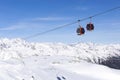 Cableway lift cable cars, gondola cabins on winter snowy mountains background beautiful scenery Royalty Free Stock Photo