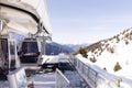 Cableway lift cable cars, gondola cabins on winter snowy mountains background beautiful scenery