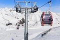 Cableway lift cable cars, gondola cabins on winter snowy mountains background beautiful scenery.