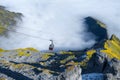 Cableway in the mountains. Transportation. The cable car descends into the mountain valley.