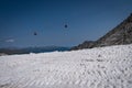 Cableway in transit over a snow-covered ski slope Royalty Free Stock Photo