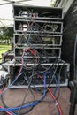 Cabling in multiple flight case racks with amplifier, effect devices, and radio microphone system on the desk of the sound mixer Royalty Free Stock Photo