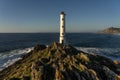 Cabo (cape) Home lighthouse on the cliffs at sunset in Rias Baixas zone in Galicia coast