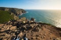 Tourists relax and take pictures on the background of beautiful view of the ocean and cliffs