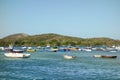 Cabo Frio, Brazil: colored wooden fishing boats moored on calm ocean bay Royalty Free Stock Photo