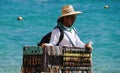 Cabo San Lucas, Mexico - November 7, 2022 - A local salesperson offering colorful jewelleries and dog collars for sale on a sunny