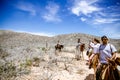 Tourists horseback riding on the beach in Cabo San Lucas, Baja California