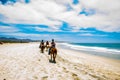 Tourists horseback riding on the beach in Cabo San Lucas, Baja California