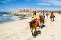 Tourists horseback riding on the beach in Cabo San Lucas, Baja California