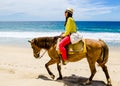 Young girl horseback riding on the beach in Cabo san Lucas, Baja California