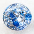 cabochon from pressed Lazurite stone on white