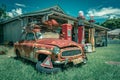 Caboolture, Queensland, Australia - Old rusty car next to the abandoned petrol station