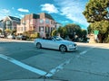 Cabriolet with luxury mansions behind Royalty Free Stock Photo