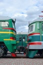 Cabs of modern Russian electric trains. Side view of the heads of railway trains with a lot of wheels and windows in the form of