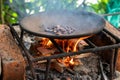 Cacao beans roasting over a smokey fire on a primitive grill, side view Royalty Free Stock Photo
