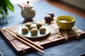 cacao date balls on bamboo mat with green tea