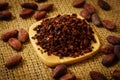 Cacao nibs and cocoa beans on burlap Royalty Free Stock Photo