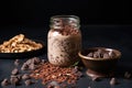 cacao nibs and oats in a jar, shot on a black slate