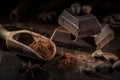 Cacao variants: powder, block chocolate and beans on dark wooden background Royalty Free Stock Photo