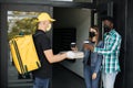 Cacasian man in face mask works on the delivery of pizza. Royalty Free Stock Photo