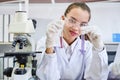 Cacausian female scientist in protective glasses looking and testing tube chemical Royalty Free Stock Photo