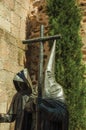 Religious bronze sculpture in front of old building wall at Caceres