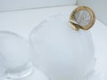 Cache euro coins in ice. Royalty Free Stock Photo