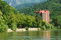 Caciulata hotel with reflections on the Olt river Royalty Free Stock Photo